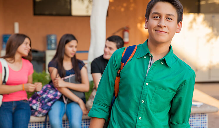 A boy in green shirt smiling