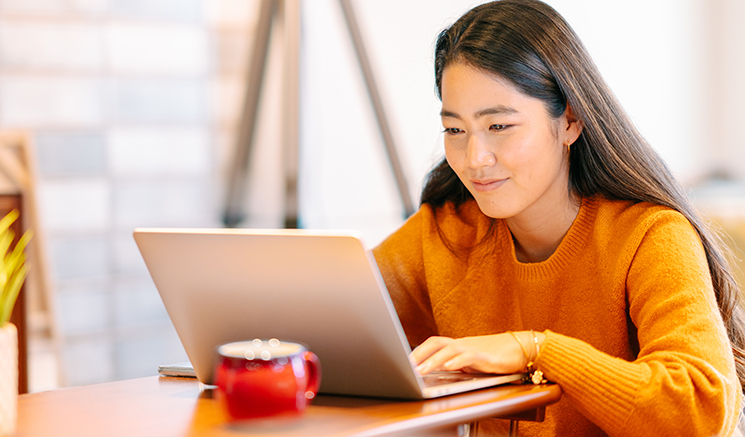 Woman with long hair using a laptop