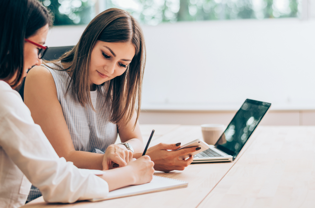 Two girls looking into laptop