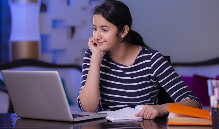 Teenager looking at laptop